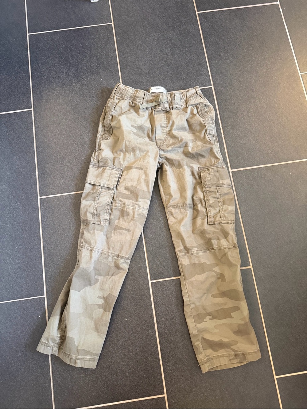 Abercrombie Kids baggy pants in a neutral tan and khaki camouflage print. Relaxe